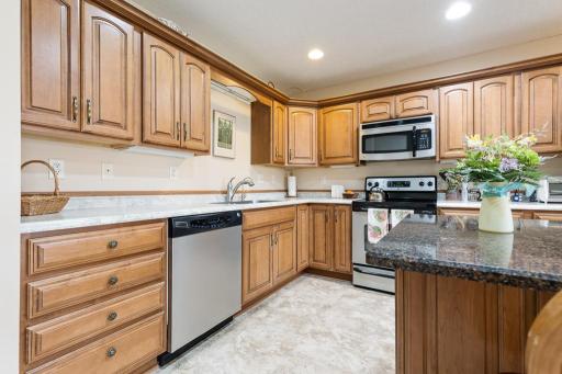 Gorgeous Cherry cabinets and stainless appliances add functionality and style to the space