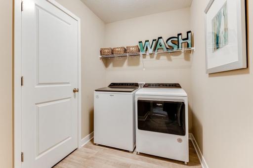 Upstairs laundry with built in shelves. *Model home photo, selections may vary.