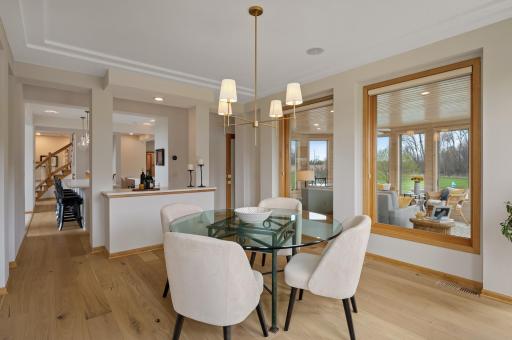 The kitchen is only steps from the formal dining with tons of sun-filled windows and more custom built-in storage.