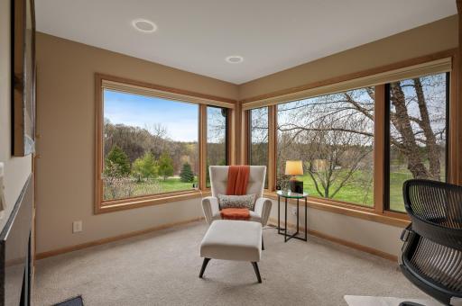 Connected to the primary bedroom is a private office with built-in bookshelf, oversized picture windows and the warmth of the double sided fireplace.