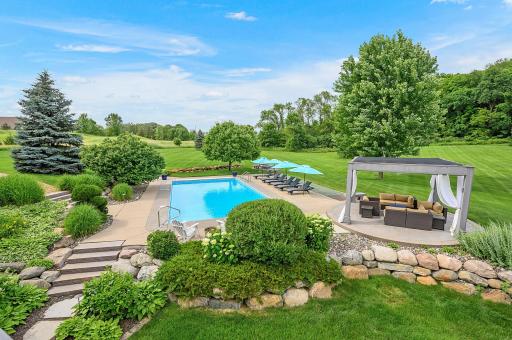 To-die-for backyard! Amazing landscaped, rolling country hills, beautiful wooded area and mature trees, and look at that pool!