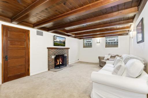 Cozy basement family room has another wood burning fireplace. Perfect space for movie night!