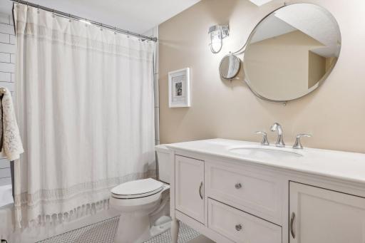 There's also a 3/4 bathroom on the lower level, with furniture-style vanity and custom ceramic tilework.