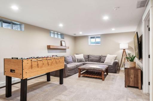 The lower level is a cozy getaway. Perfect for a play space, theater, or games.