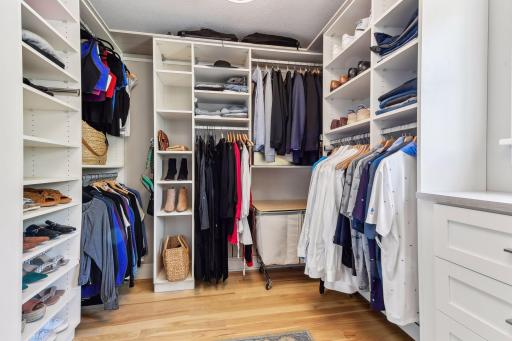The primary closet boasts California Closets organizers. There's even a stackable washer/dryer in the closet (see next photo) to make laundry a breeze.