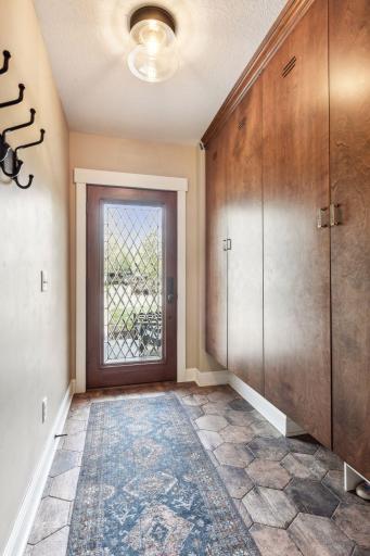 The entry from the garage is decked out with loads of storage lockers to corral everyone's gear. There's also a service door (shown here) leading out to the driveway. Heated floors keep your feet warm when you remove your shoes!