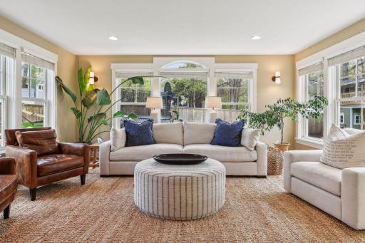 The sunroom/family room is sure to be a favorite gathering space. It walks out to the new Azek deck and fully-fenced backyard,