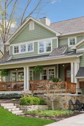Curb appeal abounds, with stacked stone walls and delightful plantings.