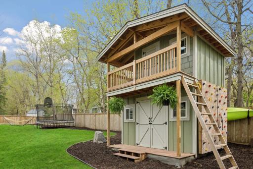 Why have just a storage shed when you can have a 2 story storage shed WITH playfort complete with climbing wall and fireman's pole?