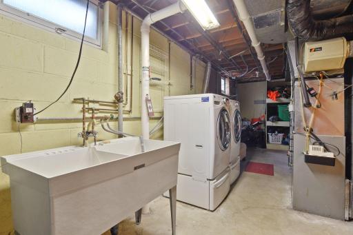 Light and bright laundry and mechanical room, with ample storage.