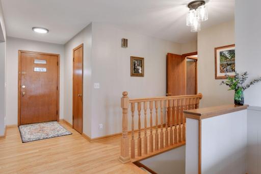 Spacious and bright foyer welcomes your guests. Gleaming hardwood floors and an open staircase help the area feel even more spacious.