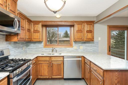Kitchen with granite tops and glass backsplash