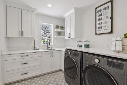 Convinient upper level laundry with plenty of cabinets for extra storage. Photos are from a previously built home.