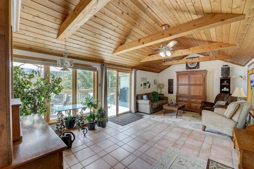 Take in this large living space with unbelievable ceilings, proceding to a new deck overlook the lake.