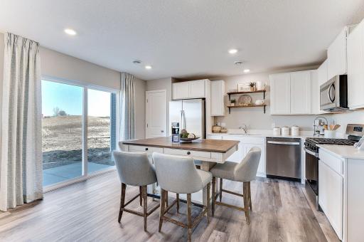 With a truly open floor plan and an abundance of light from the large windows, the Duet lives large. (Model photo, colors may vary, actual home features our Stone Grey cabinets)
