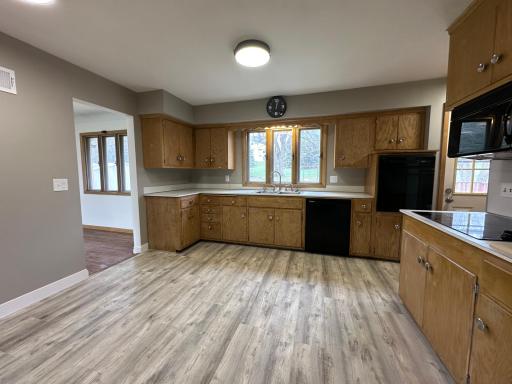 Large eat-in kitchen with original cabinets.