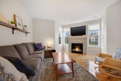 Spacious family room with a gas burning fireplace and stacked stone surround
