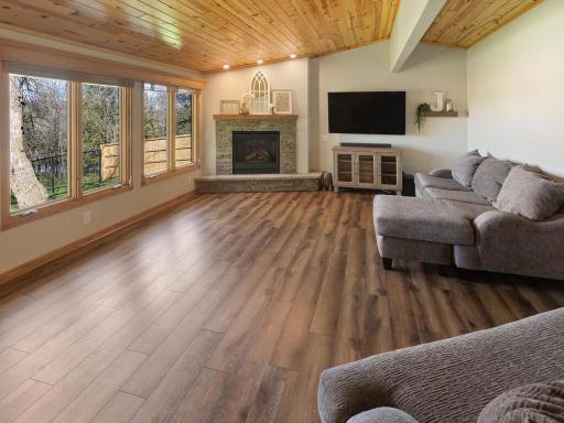 Wooden vaulted ceilings, gorgeous views, and the beautiful fireplace, along with durable LVP flooring create a relaxing place to take a breather at the end of a busy day.