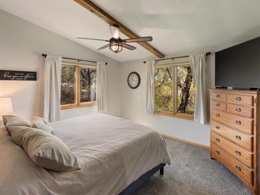 Large windows of main bedroom bring in the sunlight and open out to stunning views .