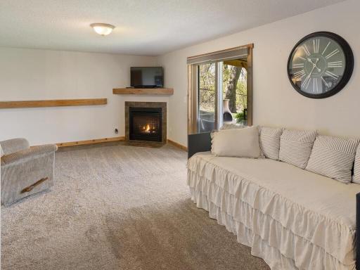 Family room boasts a warm and cozy fireplace and easy access to the covered patio space.