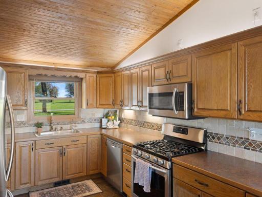 Loads of cabinets and countertops, gleaming stainless steel appliances, and stylish tile backsplash make time in the kitchen a pleasure.