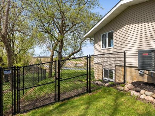 High quality chain link fencing with gates for getting yard equipment through.