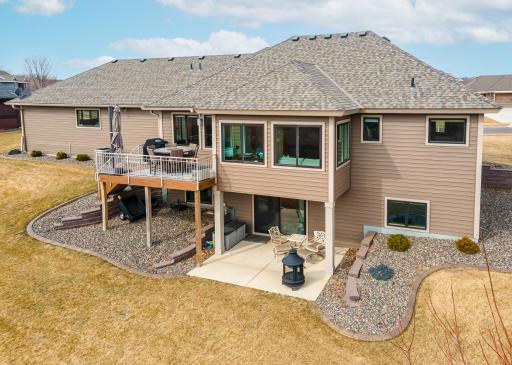 Spacious lot with maintenance-free deck, a covered patio, a playground, and spectacular panoramic views of the wetland out back.