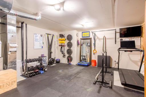 Lower-level storage/utility room - currently being used as a workout room.