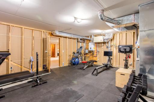 Lower-level storage/utility room - currently being used as a workout room.