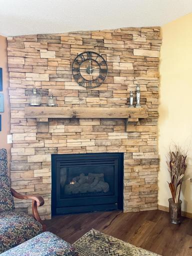 Gas fireplace with stack stone and real wood mantle