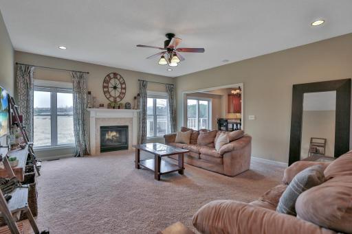 Main level living room with gas fireplace. Recessed lighting and ceiling fans throughout the home.