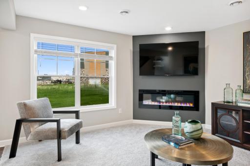 (Photo of decorated model, actual home's finishes may vary slightly) This modern fireplace is an extraordinary room accent. Enjoy the warmth of this electric fireplace as you relax in your family room.