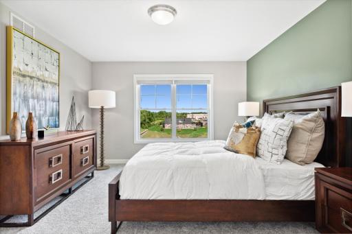 (Photo of decorated model, actual home's finishes may vary) Extremely spacious and elegant, this private owner’s suite connects to a en-suite bath providing a great oasis to relax in your own private space in addition to a large walk-in closet.