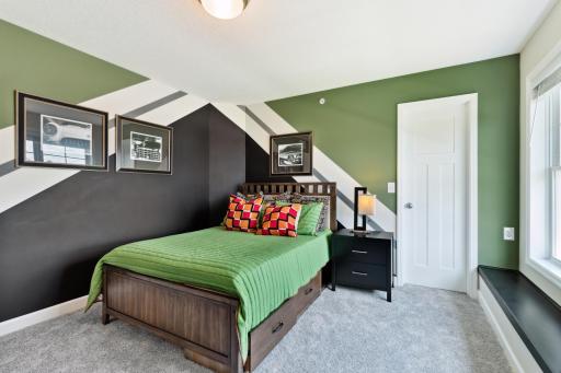 (Photo of decorated model, actual home's finishes may vary slightly) The home's two secondary bedrooms are located on the upper level and each feature a spacious closet.
