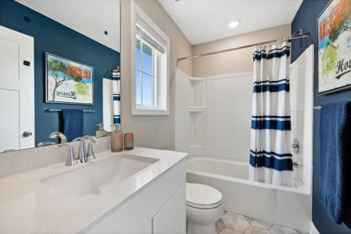 (Photo of decorated model, actual home's finishes may vary slightly) The upper level bath provides plenty of space for everyone to get ready in the morning!