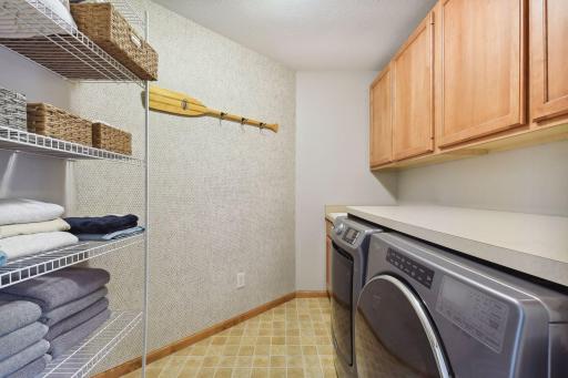 Conveniently located on the upper level is the laundry room which offers built-in cabinetry and shelving, a laundry sink and folding counter. The washer was installed in 2021 and a new dryer in 2024.