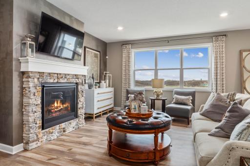 (Photo is of a model, homes finishes vary) The great room features a gas fireplace and plenty of natural light.
