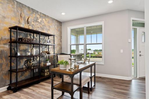 (Photo is of a model, homes finishes vary) Located just off the foyer, this main level flex room provides endless opportunities; including a home office, formal dining area, a playroom or another sitting room.