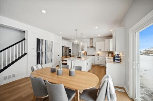 (Photo of model, actual features may vary) The focal point of this modern kitchen is an inviting center island that provides additional counter and seating space. It is surrounded by ample cabinetry and all-new stainless steel appliances.