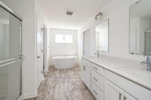 The en-suite owner's bath is one-of-a-kind, with double sinks and a walk through layout. Not to mention the gorgeous tub to bring a sense of relaxation and classic design