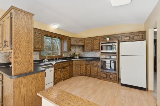 A vintage kitchen that is so cute! Quality cabinets, black countertops and laminate flooring.