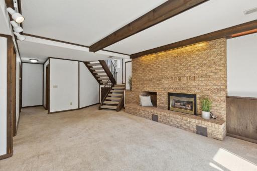 Gas fireplace is inset in the brick surround.