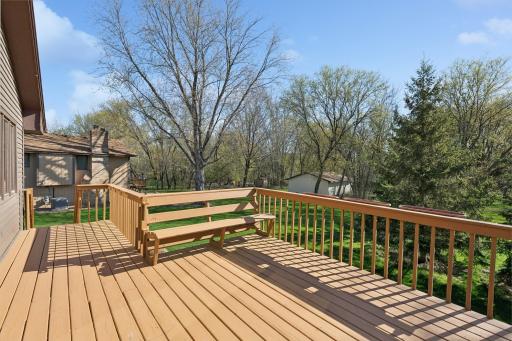 Deck with stairs leading to the yard and even built in bench.