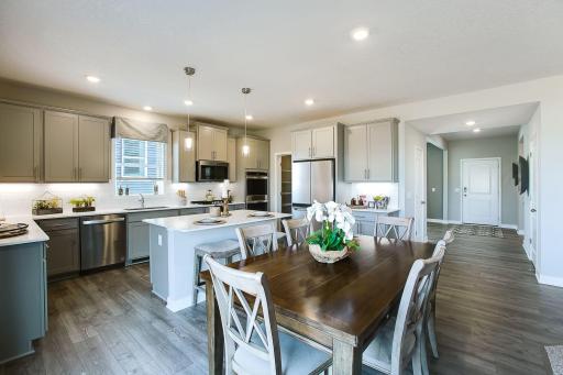 The Jordan's 'L' shaped kitchen allows for storage and work-space! Bright light from the window over the sink, stainless appliances, quartz counters, and tile back splash. This is our signature kitchen package with double ovens and gas cooktop.