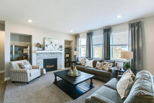 Natural sunlight and a cozy fire in this lovely main level great room.