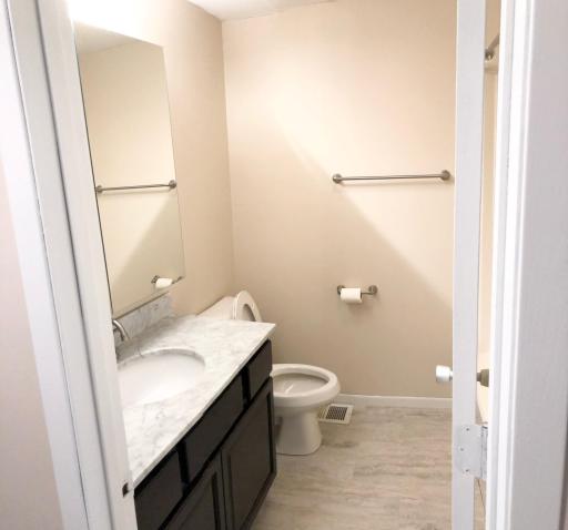 Upper level full bath with updated flooring and vanity.