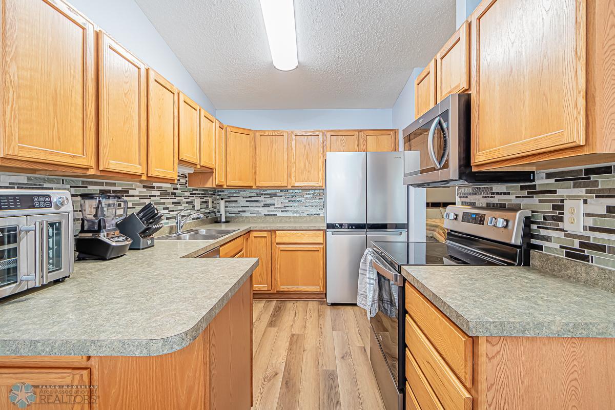 Laminate flooring, tile backsplash, Stainless appliances with fabulous refrigerator