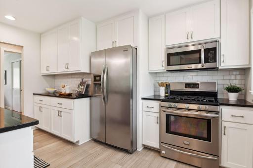 Kitchen with custom cabinets, granite counters, and stainless appliances updated in 2015.