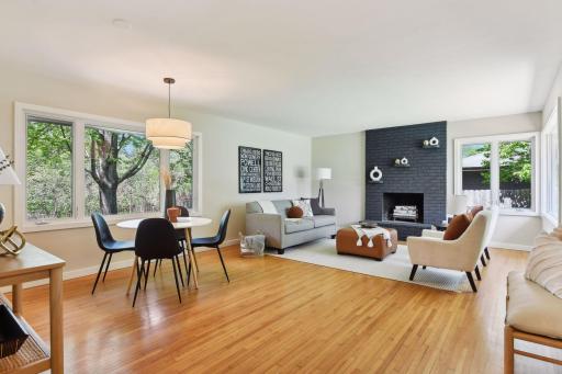 Sunny open floor plan with wood-burning FP, hardwood floors, and fabulous light from windows on the east and west.
