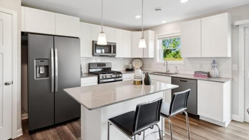 (Photo of a decorated model, actual homes finishes will vary) Welcome to the Madison! The gas range and microwave oven are busy cook's best friends.
